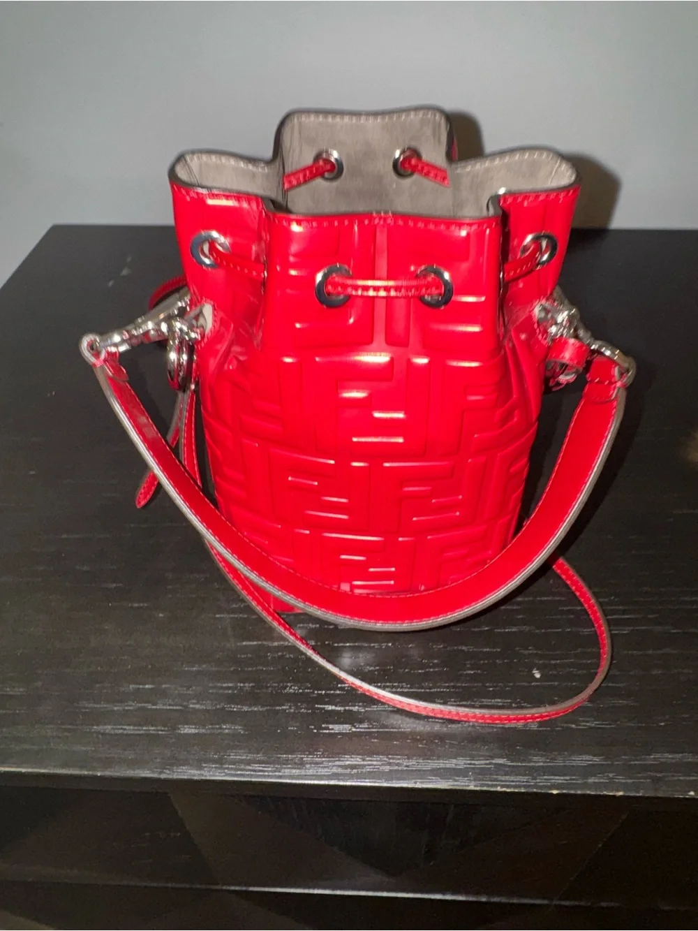 Fendi Mon Tresor mini bucket bag in a vibrant red hue with embossed FF logos